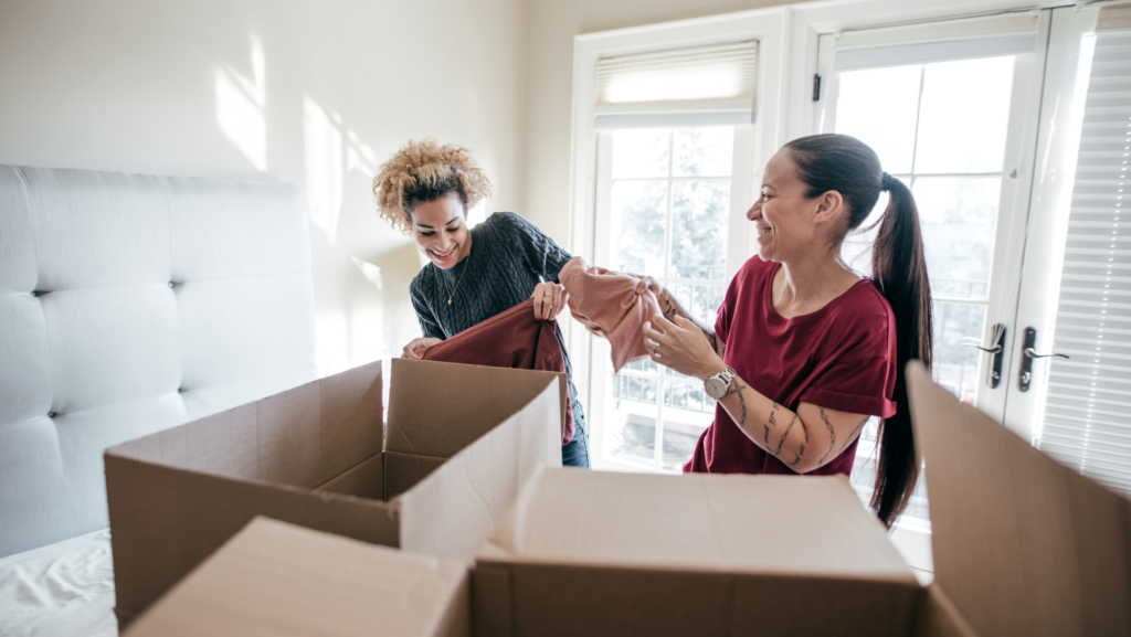 two women unpacking and laughing